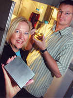 Dr. Patricia Irving holds the InnovaGen™ micro-channel reactor while Staff Engineer Jeff Pickles looks on - Tri-City Herald